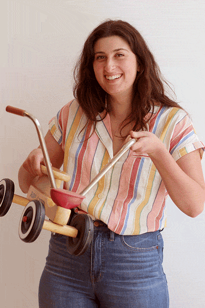 Gif of TGW Studio intern Alison Lindsey holding a toy bicycle