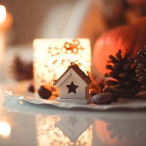 holiday decor such as pinecones, candles, and a miniature house