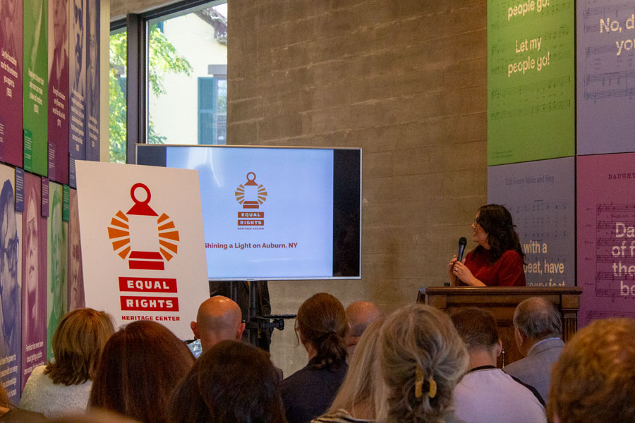 Photo of the Equal Rights Heritage Center brand unveiling with a group of people looking at a screen