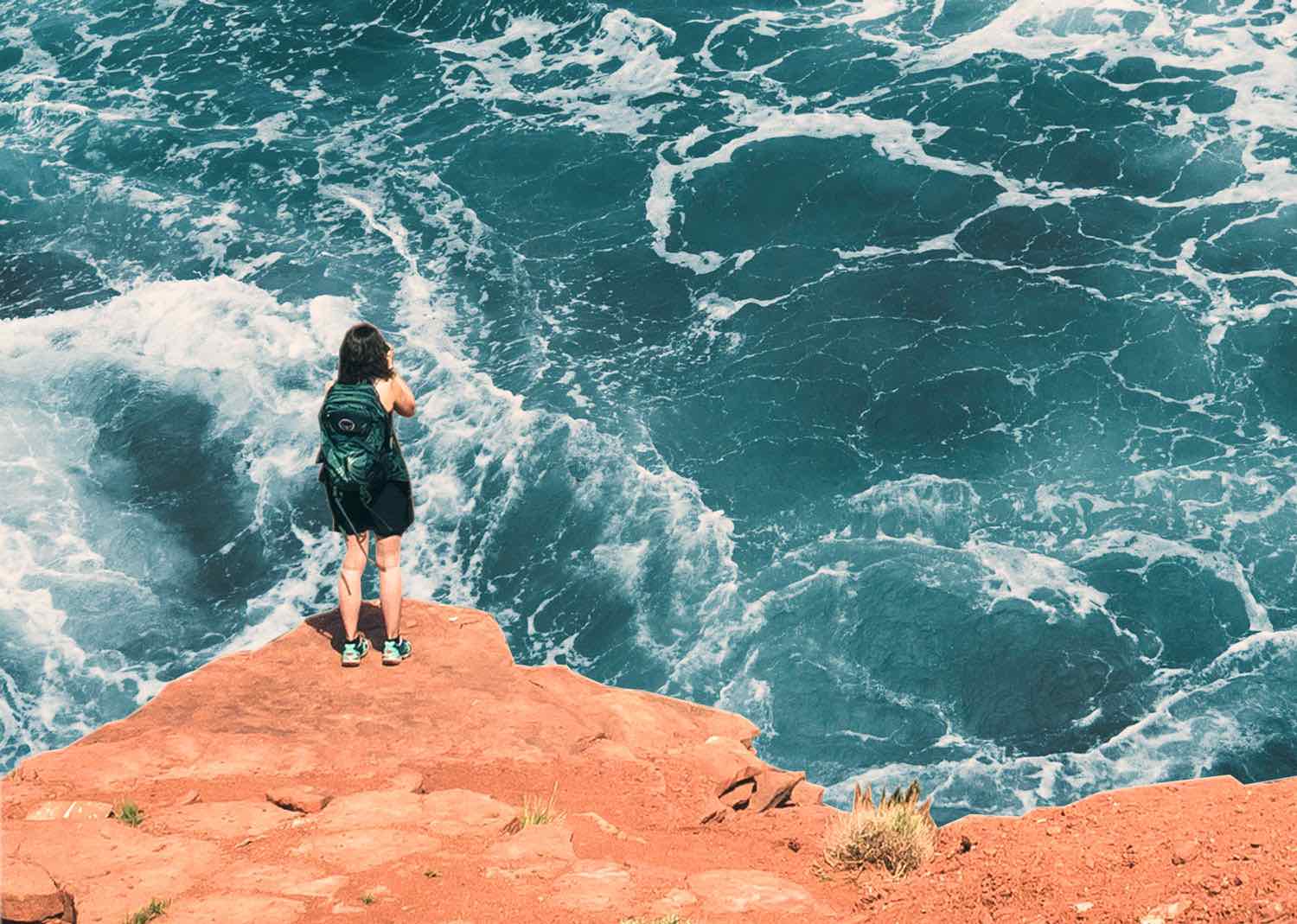 Collaged photos of a person standing on a cliff taking a photo of the water below
