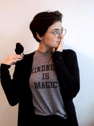 GIF of Lily Garnaat, TGW Studio intern, with a fake bird on their shoulder