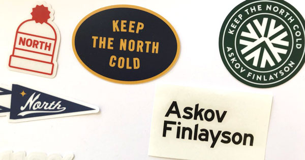 Photo of patches that include a hat that says 'North' on it, a circular patch that says 'keep the north cold', a circular patch that says 'Keep the North Cold, Askov Finlayson', a pennant that says 'North' and a post it that says 'Askov Finlayson' for Shopping Good post