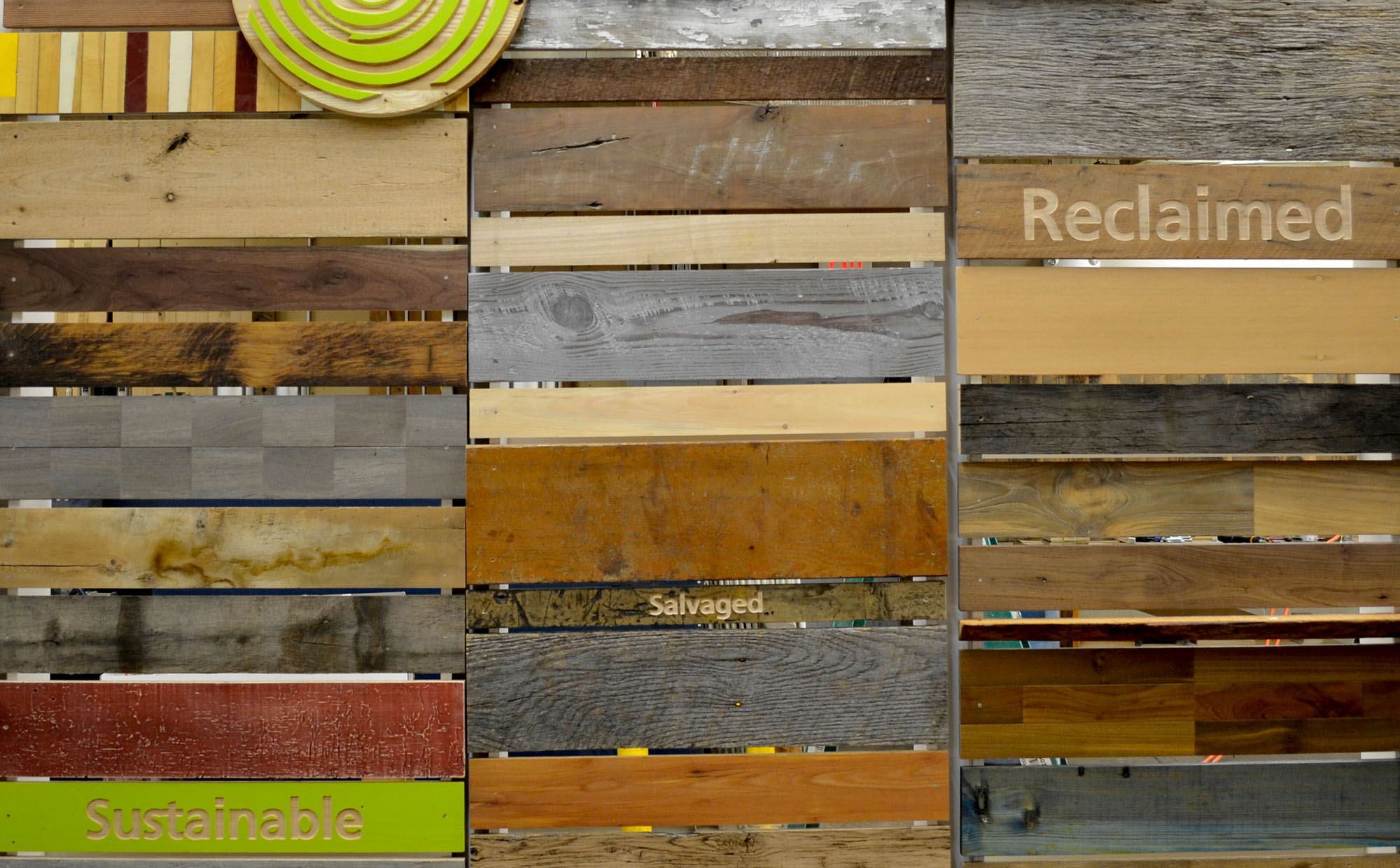 Photo of Pioneer Millworks multicolor wood samples with text that says 'sustainable, salvaged, and reclaimed'