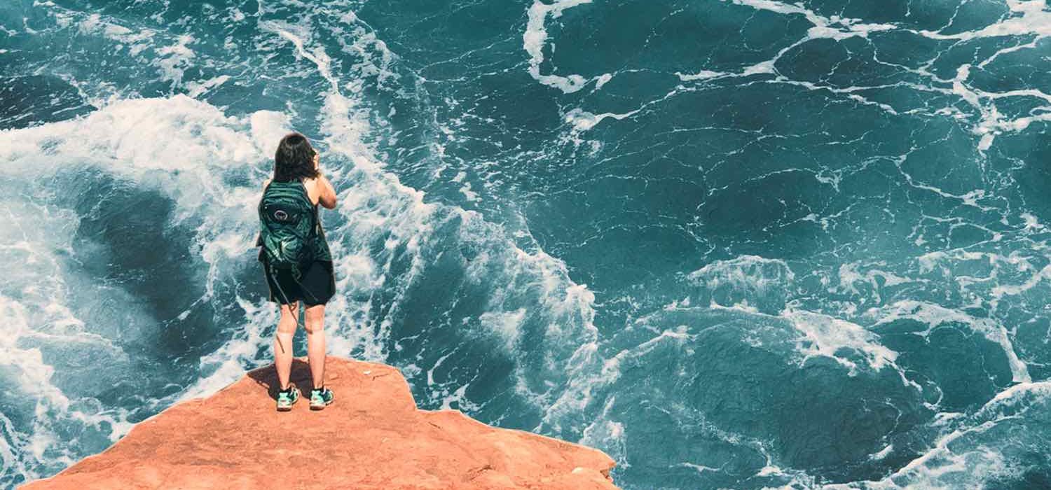 Collaged photos of a person standing on a cliff taking a photo of the water below